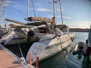 Outremer 45 2004 Outremer 45 catamaran docked at marina, sunny day, calm waters.