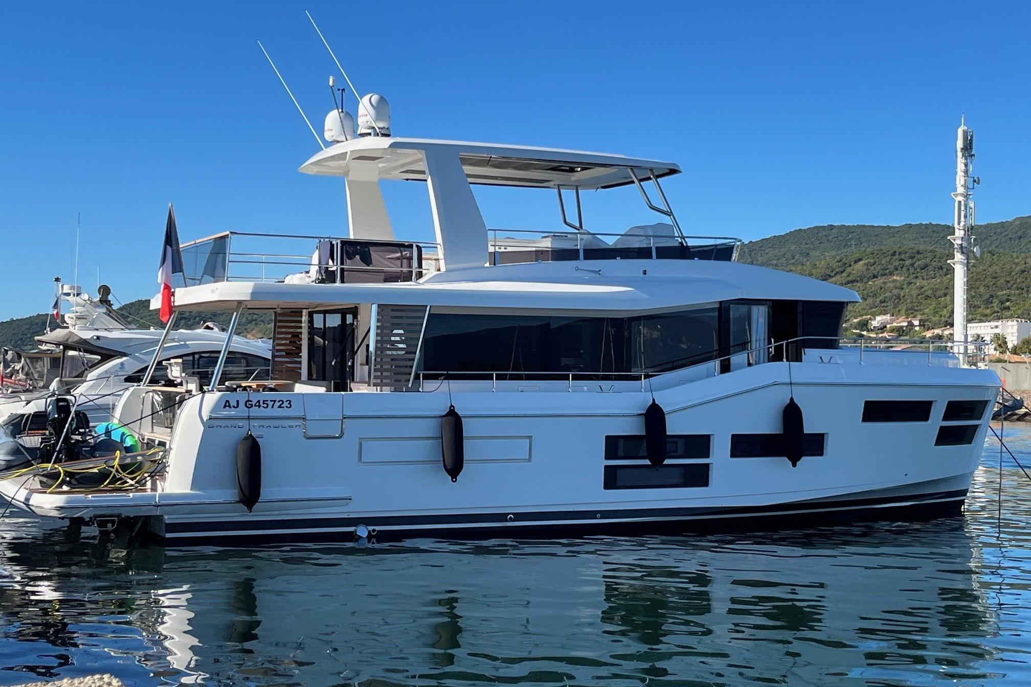 Beneteau swift trawler 62 2022 Beneteau Swift Trawler 62 docked in a scenic marina setting.