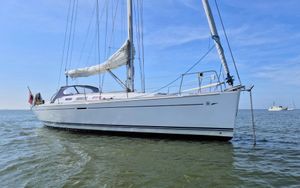 Dufour 40 Performance 2006 Dufour 40 Performance sailboat anchored on calm water under a clear blue sky.
