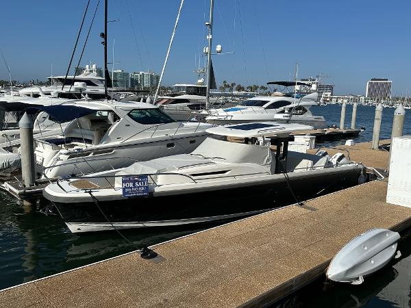 Nimbus T11 2023 Nimbus T11 boat docked, for sale sign visible, marina background.