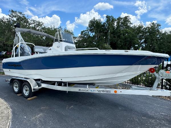 NauticStar 211 Hybrid 2024 NauticStar 211 Hybrid boat on a trailer, blue and white hull.