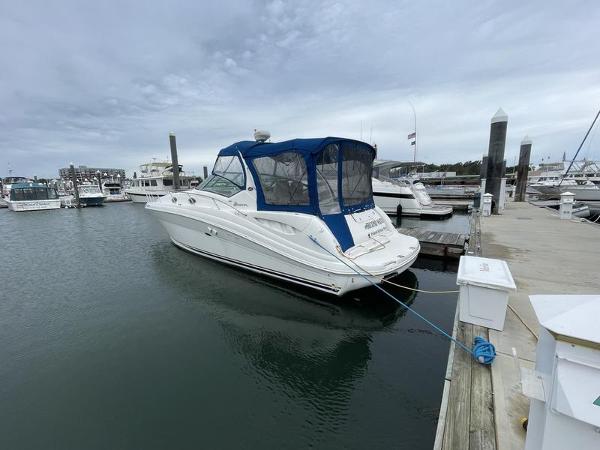 Sea Ray 340 Sundancer 2003 Sea Ray 340 Sundancer docked at marina under cloudy sky.