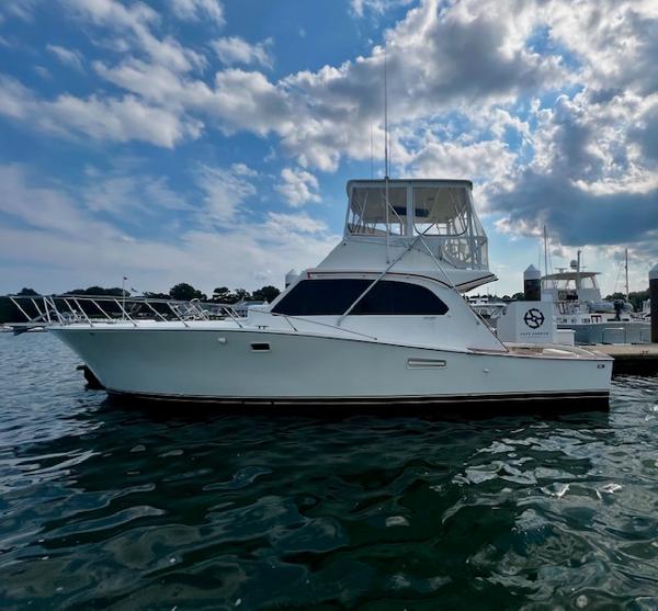 Post 43 Convertible 1985 Post 43 Convertible yacht on water under cloudy sky.