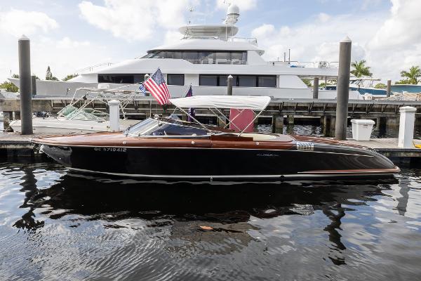 Riva Aquariva Super 2013 Riva Aquariva Super boat docked, featuring sleek design and American flag.