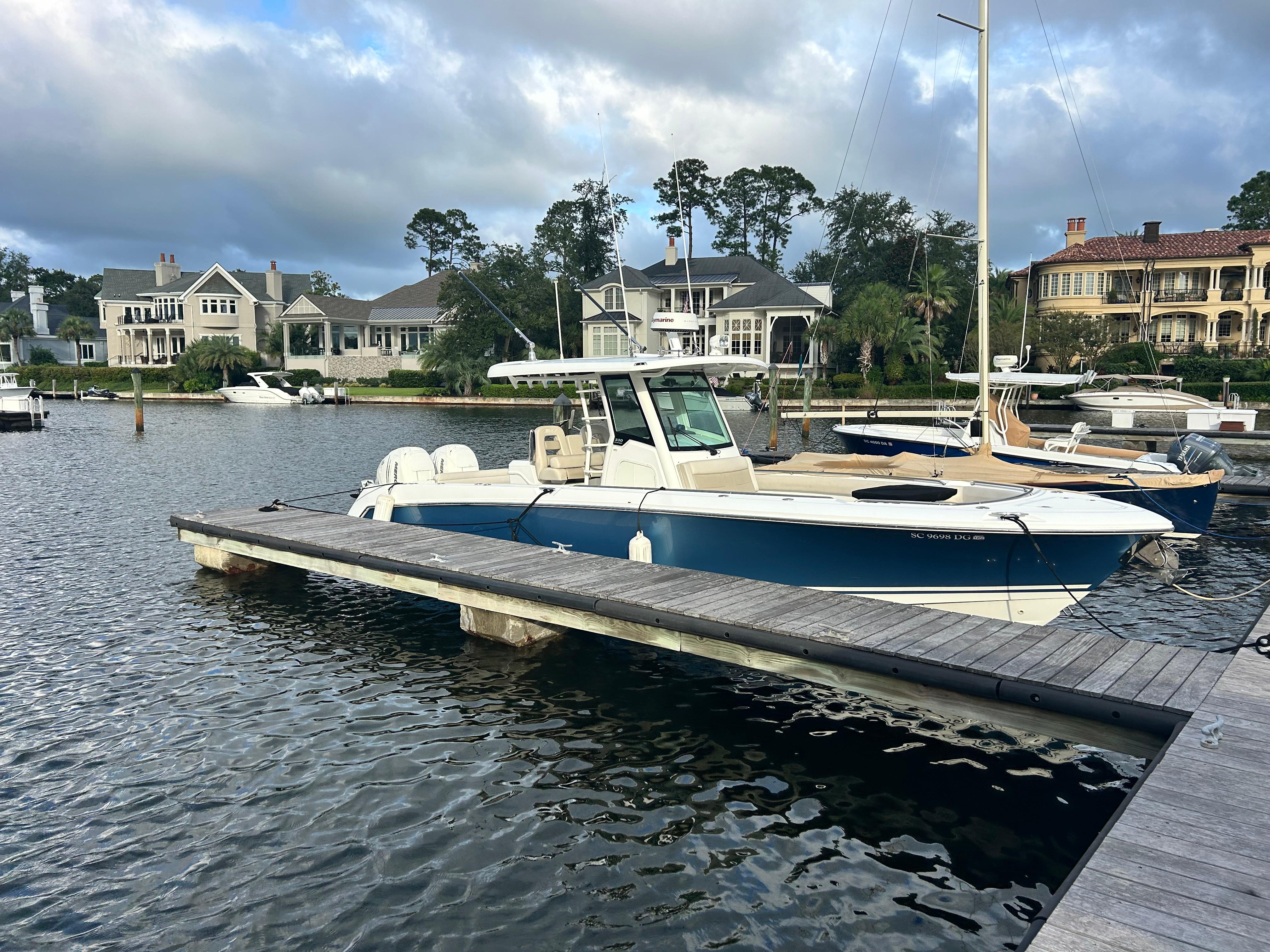 Boston Whaler 330 Outrage 2017 Boston Whaler 330 Outrage docked in a scenic marina setting.