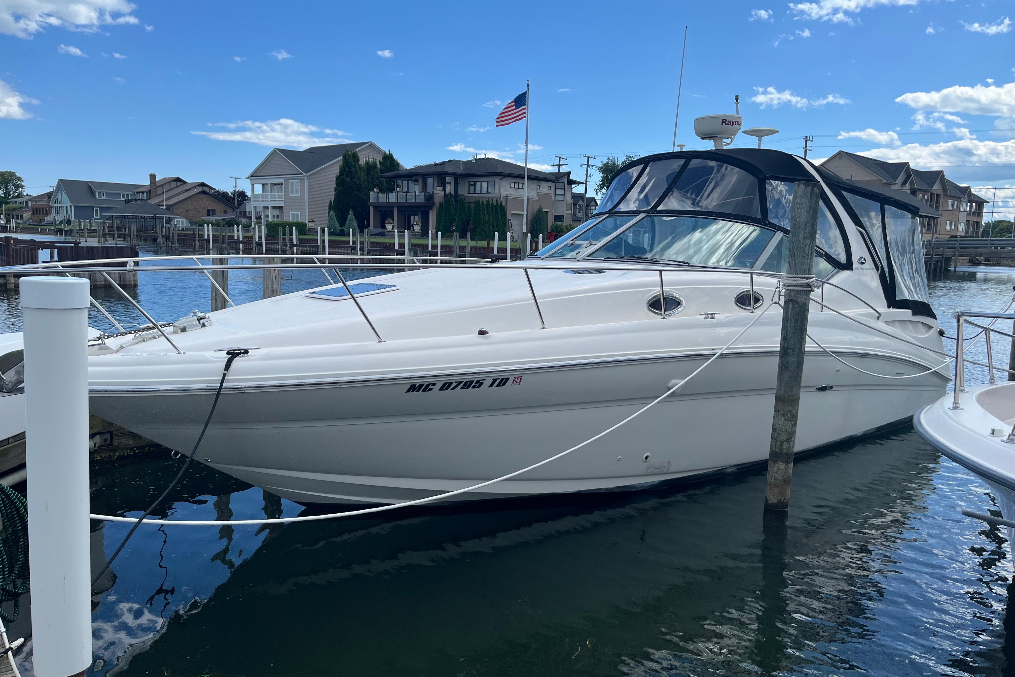 Sea Ray 320 Sundancer 2002 Sea Ray 320 Sundancer docked in a marina with clear skies.