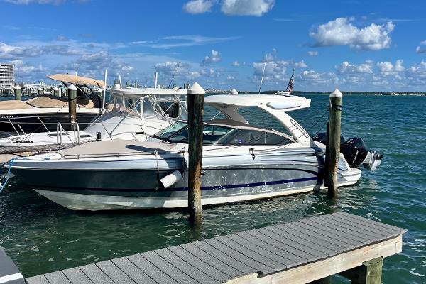 Formula 330 CBR 2023 Formula 330 CBR boat docked at marina under blue sky.