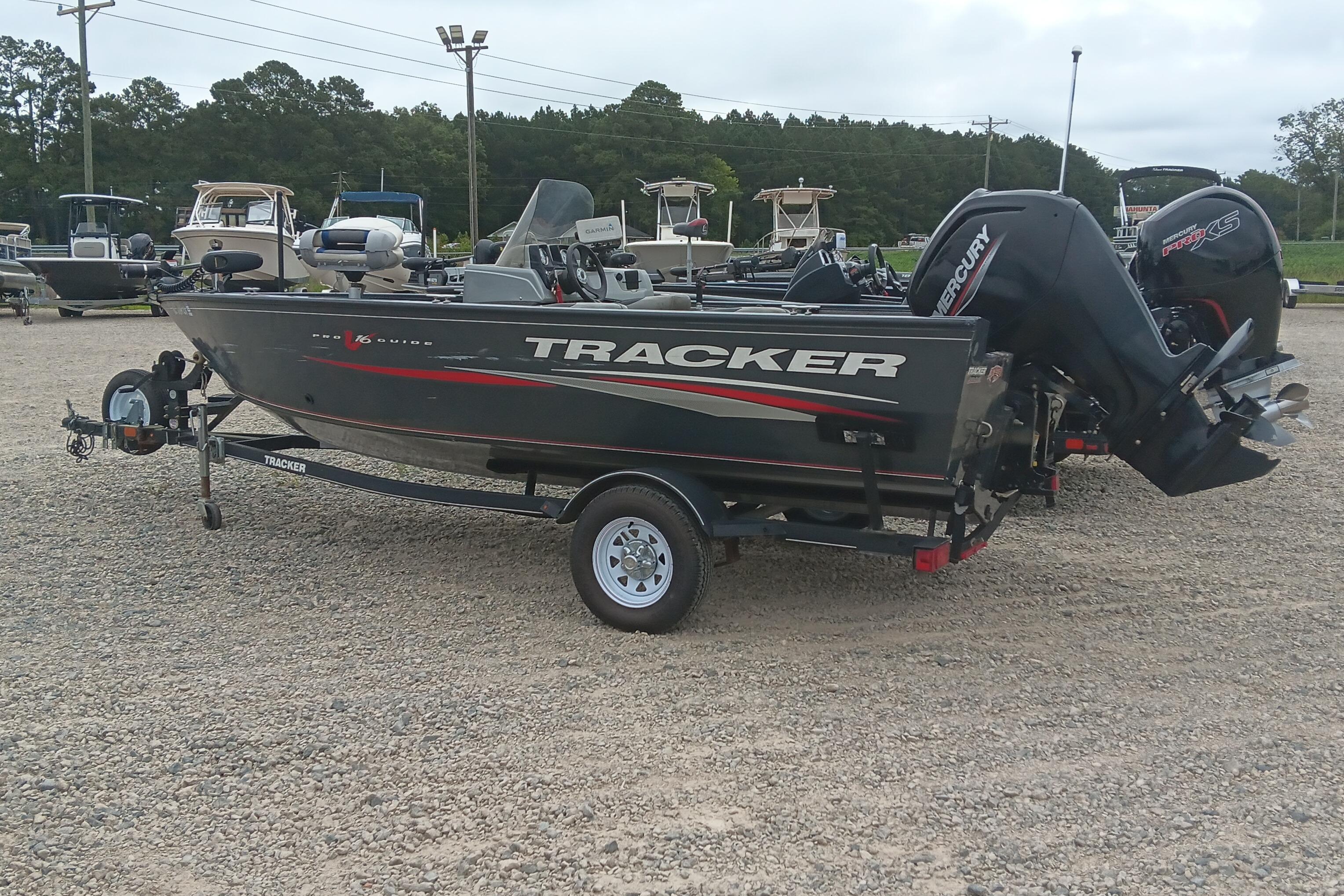 Tracker Pro Guide V-16 SC 2019 Tracker Pro Guide V-16 SC boat on trailer, parked in a gravel lot.
