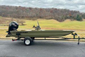 Tracker Grizzly 1860 CC 2026 Tracker Grizzly 1860 CC boat on trailer, scenic countryside background.