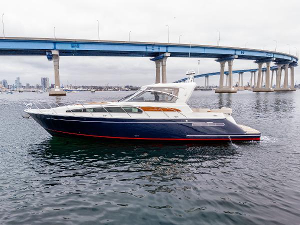 Chris-Craft Roamer 40 2006 Chris-Craft Roamer 40 yacht cruising under a blue bridge on a cloudy day.