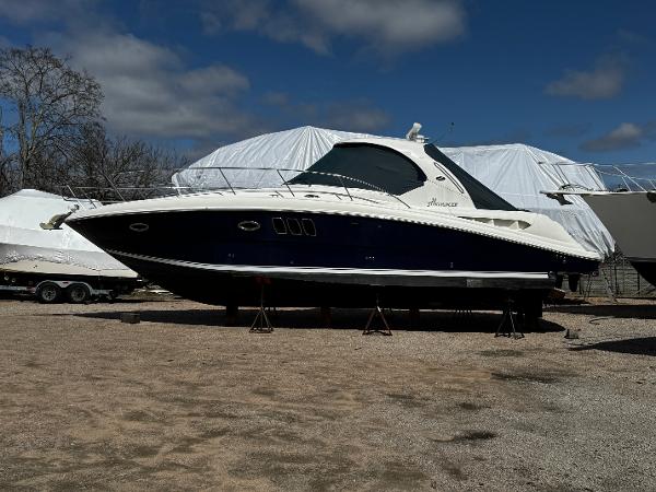 Sea Ray 380 Sundancer 2006 Sea Ray 380 Sundancer yacht on stands, outdoor storage, clear sky.