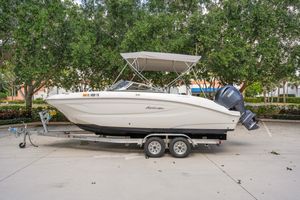 Hurricane SunDeck 2050 OB 2025 Hurricane SunDeck 2050 OB boat on trailer, parked outdoors with trees in background.