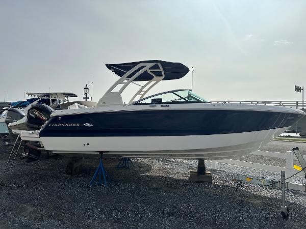 Chaparral 250 OSX 2024 Chaparral 250 OSX boat displayed on a gravel lot.