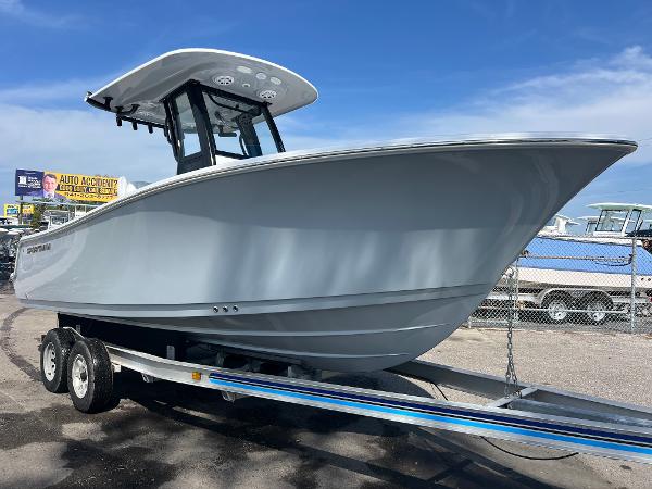 Sportsman Open 212 Center Console 2025 Sportsman Open 212 Center Console boat on trailer, parked outdoors under blue sky.
