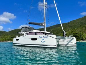 Fountaine Pajot Elba 45 2023 Fountaine Pajot Elba 45 catamaran anchored in clear blue waters.