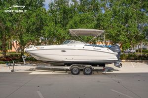 Hurricane SunDeck 2400 OB 2025 Hurricane SunDeck 2400 OB boat on trailer, parked outdoors with trees in background.