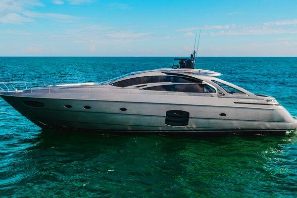 Pershing 70 2015 Pershing 70 yacht cruising on open sea under clear blue sky.