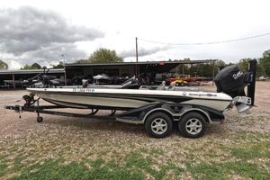 Ranger Z521 Comanche 2014 Ranger Z521C Comanche boat on trailer, parked outdoors under cloudy sky.