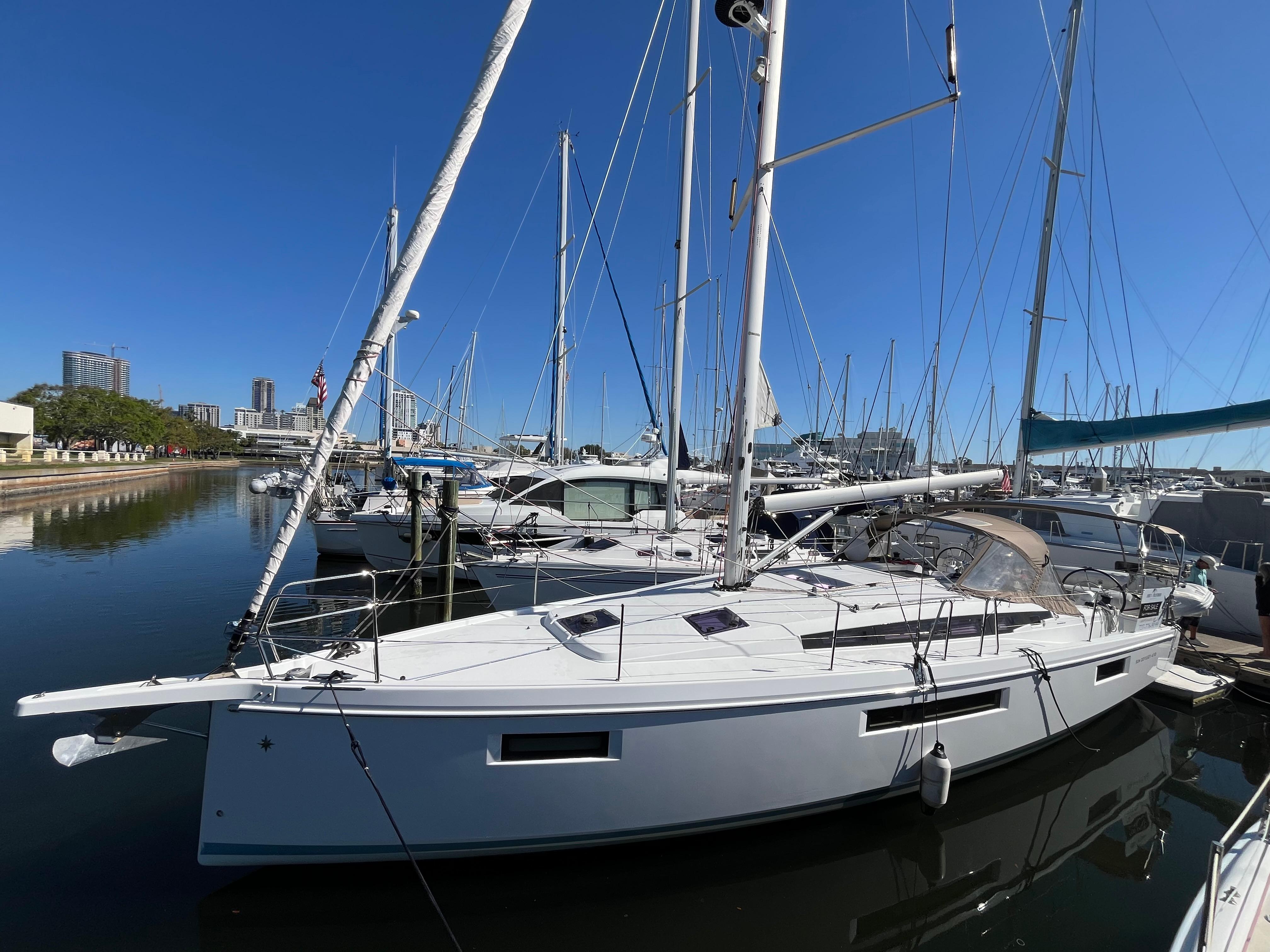 Jeanneau 410 Sun Odyssey 2020 Jeanneau 410 Sun Odyssey yacht docked in a marina under clear blue skies.