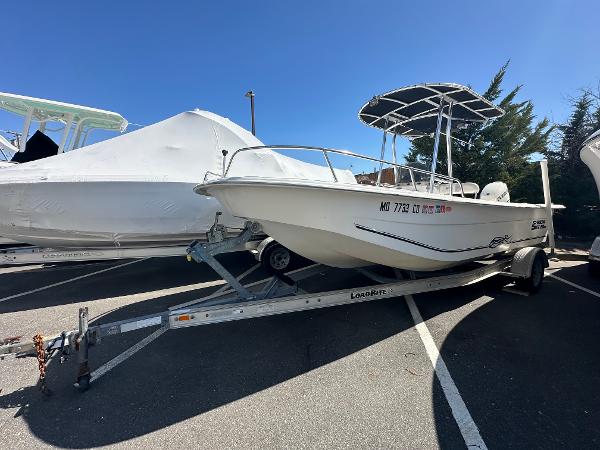 Carolina Skiff 218 DLV 2011 Carolina Skiff 218 DLV boat on trailer in parking lot, sunny day.