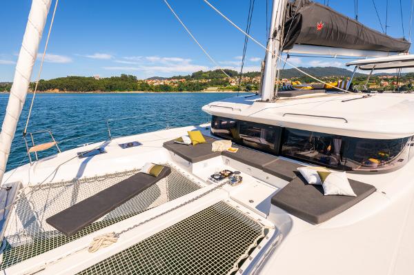 Lagoon 43 Luxurious 2025 Lagoon 43 catamaran with sunbathing area on tranquil blue waters.
