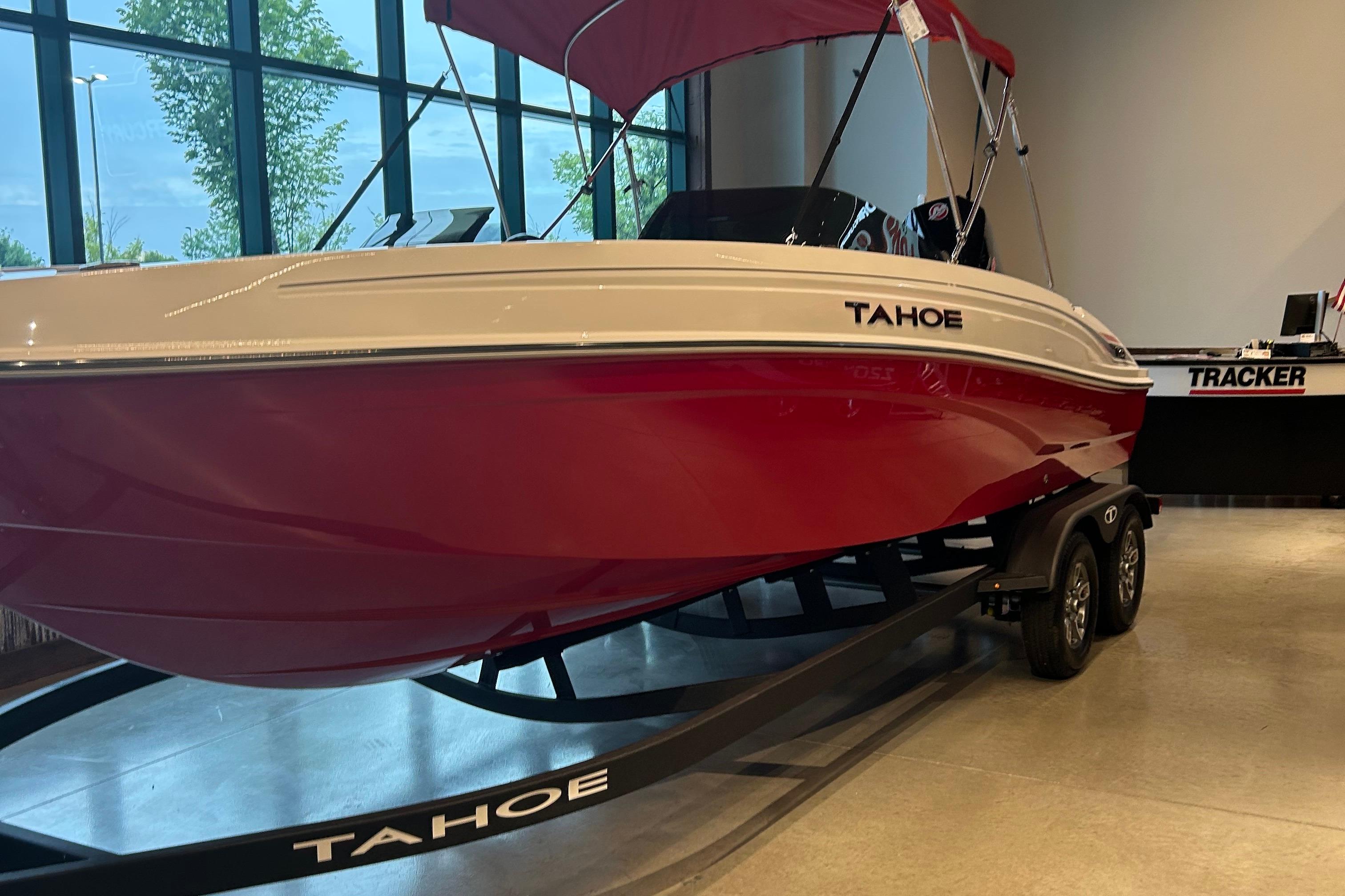 Tahoe T21 2025 Tahoe T21 boat with red hull on display indoors.