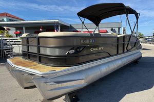 Crest Caribbean 250 SLS 2019 Crest Caribbean 250 SLS pontoon boat with canopy, docked at marina.