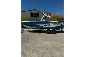 Axis T235 2024 Axis T235 boat on trailer, parked outside a building on gravel.