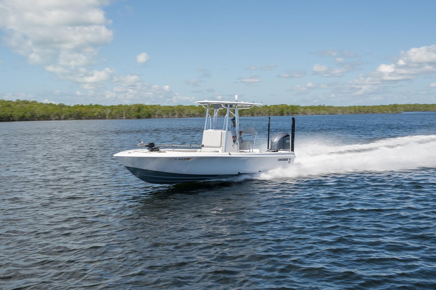 Contender 26 Bay 2024 Contender 26 Bay boat speeding on open water under clear skies.