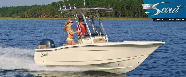 Scout 195 Sportfish 2024 Scout 195 Sportfish boat cruising on a lake with two passengers.