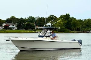 Pursuit C 280 Center Console 2008 Pursuit C 280 Center Console boat on calm water near shoreline.