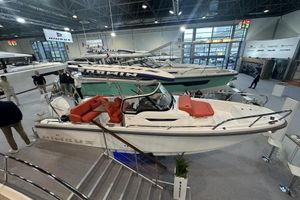 Nimbus T8 2024 Nimbus T8 boat displayed at an indoor exhibition with red seating and modern design.