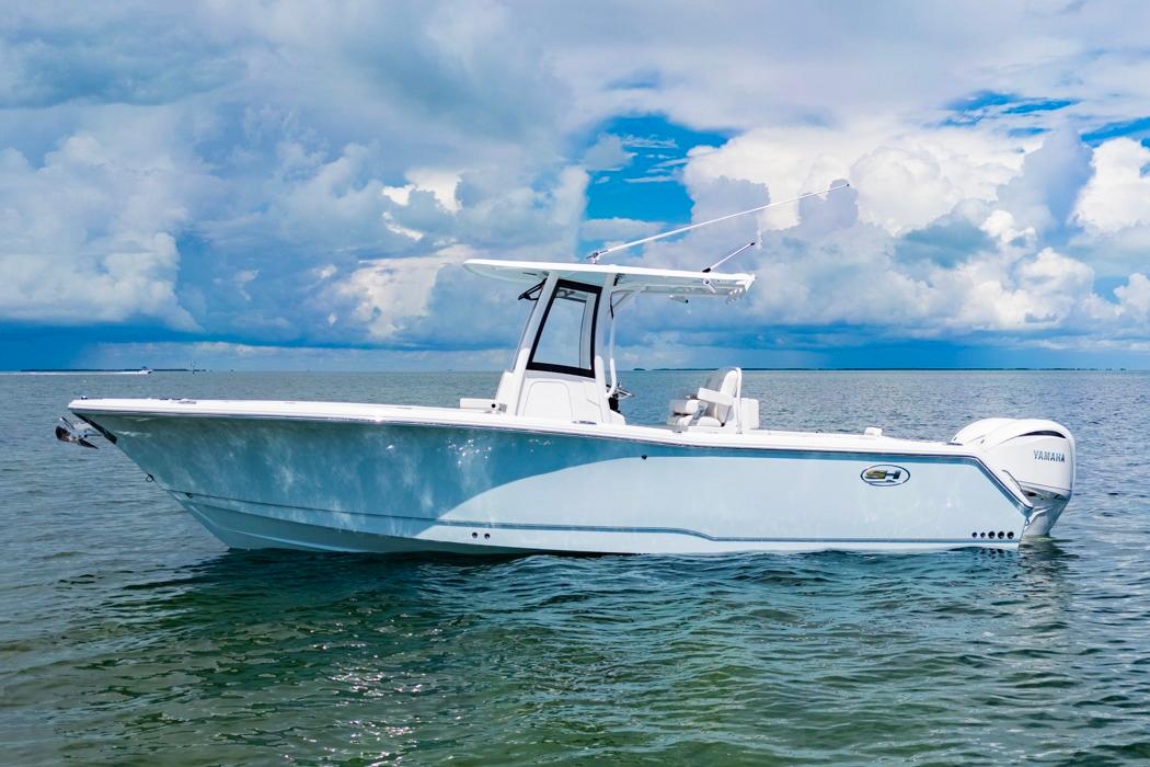 Sea Hunt Gamefish 27 Coffin Box 2026 Sea Hunt Gamefish 27 Coffin Box boat on calm ocean waters under cloudy sky.