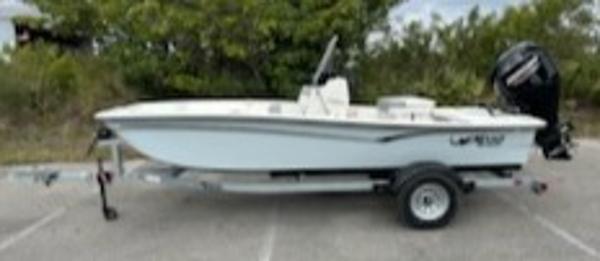 Mako Pro Skiff 15 CC 2025 Mako Pro Skiff 15 CC boat on trailer, parked outdoors.