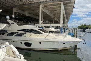 Azimut 55E 2006 Azimut 55E yacht docked in a marina under a covered structure.