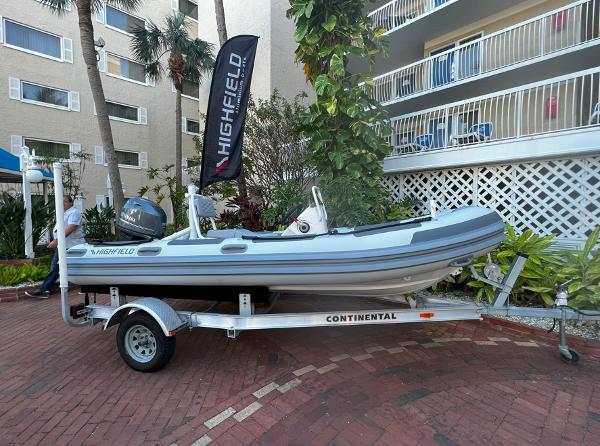 Highfield Patrol 460 2023 Highfield Patrol 460 boat on trailer, displayed outdoors near a building.