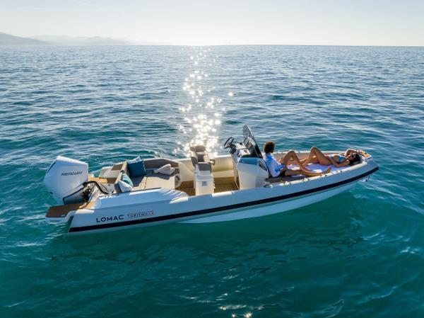 Lomac Turismo 7.0 2024 Lomac Turismo 7.0 boat cruising on clear blue ocean waters.