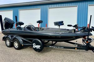 Ranger Z519 2017 Ranger Z519 boat with trailer, parked outside blue garage doors.