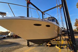 Sea Ray 310 Sundancer 2001 Sea Ray 310 Sundancer boat on lift under clear blue sky.