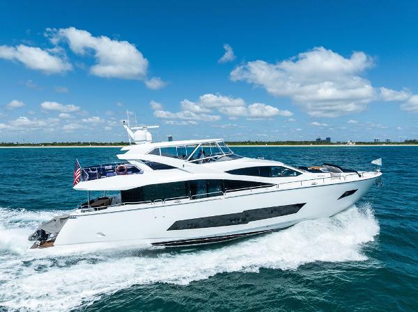 Sunseeker 86 Yacht 2019 Sunseeker 86 Yacht cruising on blue ocean under clear sky.