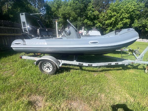 Highfield Sport 420 2025 Highfield Sport 420 boat on trailer, parked on grass with trees in background.