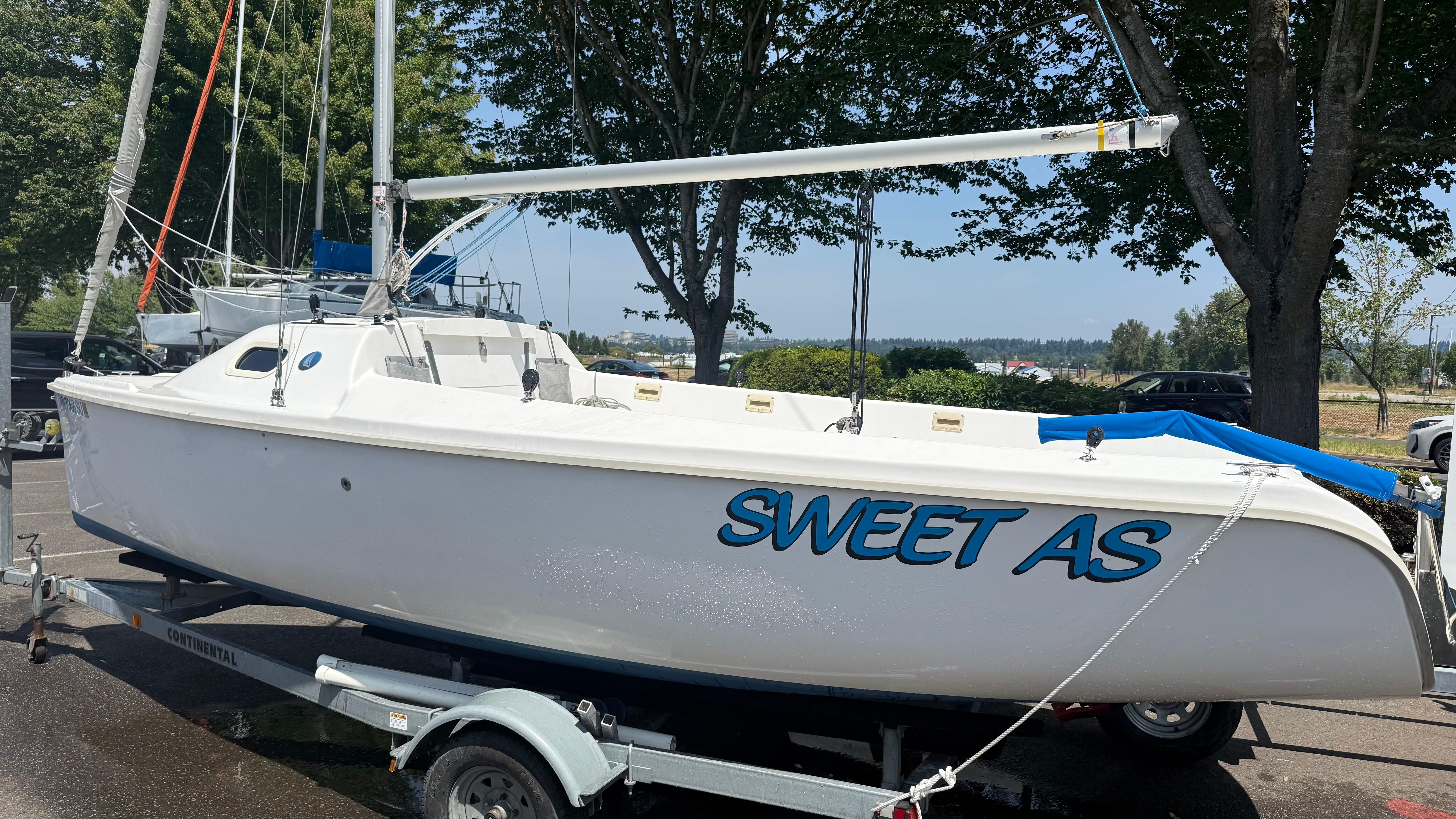 Marlow-Hunter 22 2011 Marlow-Hunter 22 sailboat named "Sweet As" on a trailer, parked outdoors.