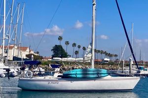 Catalina 36 1985 Catalina 36 sailboat docked in a marina with palm trees in the background.