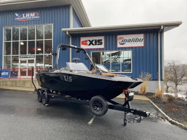 Axis A225 2025 Axis A225 boat on trailer outside dealership, overcast day.