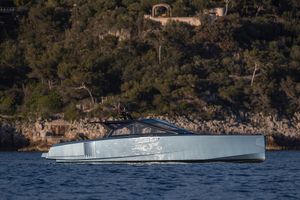 Wally WALLYPOWER58 2022 Wally WALLYPOWER58 yacht cruising near a rocky, forested coastline.