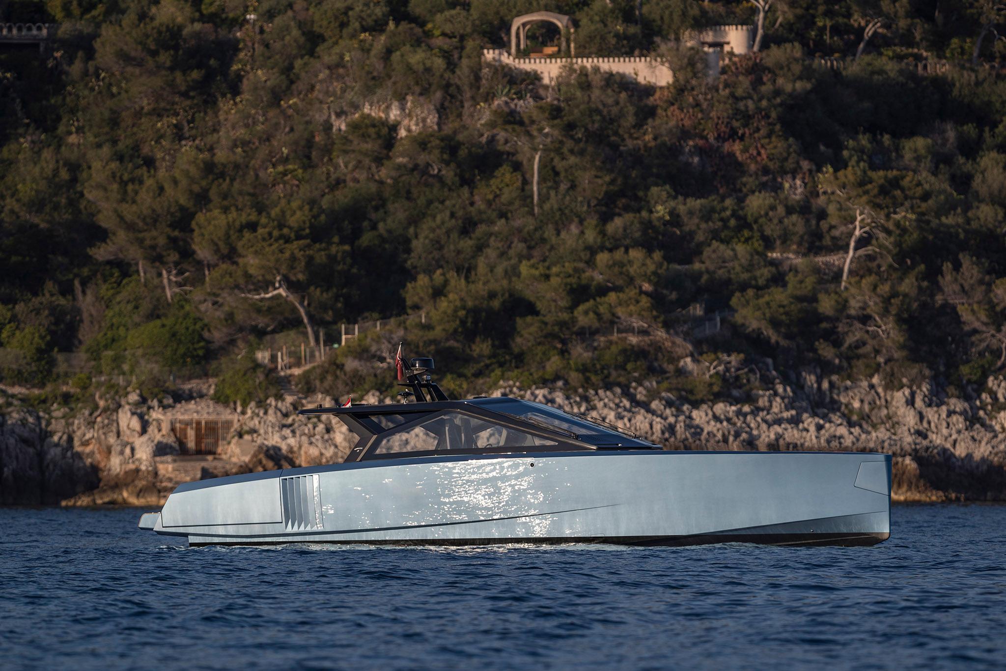 Wally WALLYPOWER58 2022 Wally WALLYPOWER58 yacht cruising near a rocky, forested coastline.