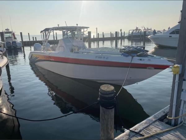 Donzi 35 Zf 2004 Donzi 35 ZF boat docked at a marina, calm water, clear sky.