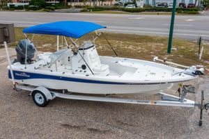 NauticStar 214 XTS 2014 NauticStar 214 XTS boat with blue canopy on a trailer.