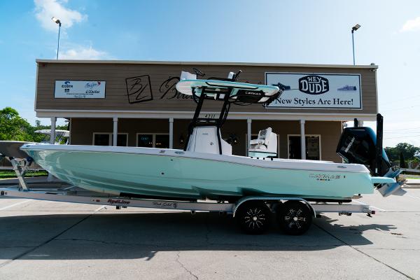 Caymas 28 HB 2025 Caymas 28 HB boat on trailer in front of store, sunny day.