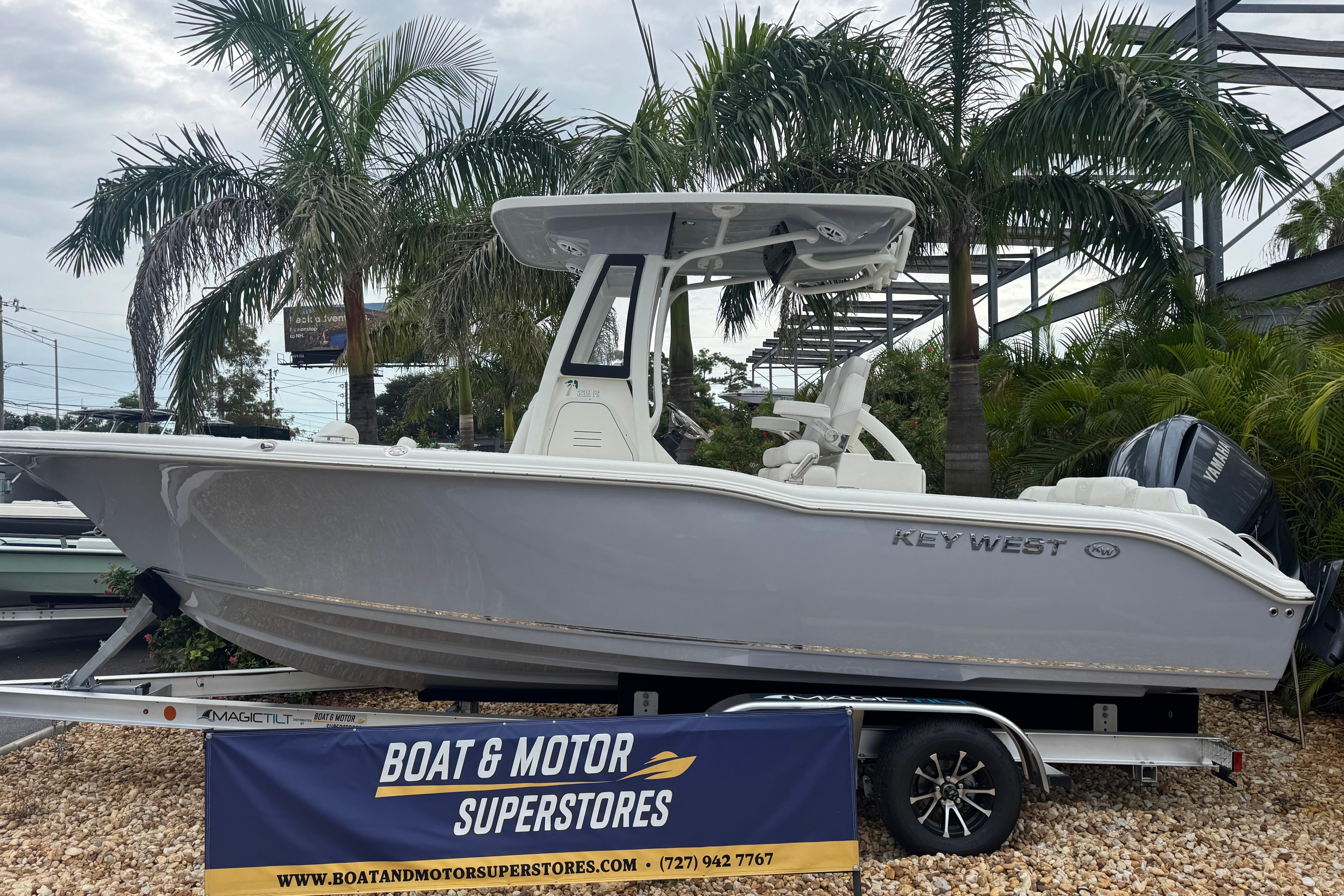 Key West 239 FS 2026 Key West 239 FS boat displayed at dealership with palm trees in background.